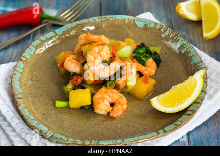 Prawn and pineapple stir fry with pak choi and chili sauce Stock Photo
