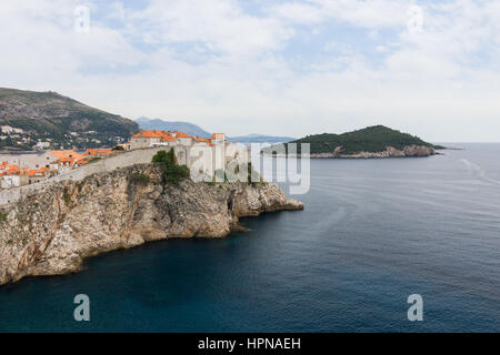 View of Mediterranean Sea, Old Town and City Walls on a steep cliff and Lokrum Island in Dubrovnik, Croatia. Stock Photo
