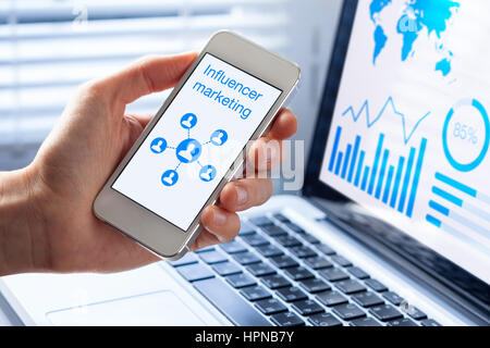 Inlfuencer marketing concept on a mobile phone screen with a diagram showing a social network advertising strategy with communication to people Stock Photo