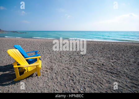 One of the many pairs of colourful Muskoka style chairs randomly placed on Kew beach in the beaches district of Toronto Ontario Canada. Stock Photo