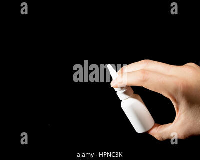 White bottle of nasal spray on black background Stock Photo