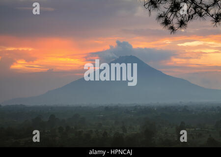 Colourful Sunset mountain Mount Sinabung in the Karo Highlands of North Sumatra, Indonesia. This highly active volcano which has erupted a number of t Stock Photo