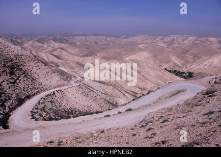 View of empty winding road leading to Wadi Qelt also Wadi Kelt or Nahal Prat (Hebrew) a valley at the Judaean or Judean desert in the West Bank, originating near Jerusalem and terminating near Jericho. Israel Stock Photo