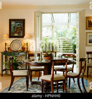 A Country Style Dining Room With French Doors Leading Outside A Country Style Dining Room With French Doors Leading Outside