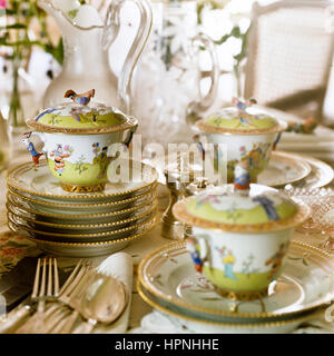 Antique tableware on a dining table. Stock Photo