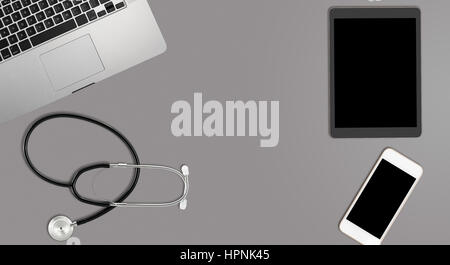 Clean and tidy grey desk with equipment ready for medical doctor using latest technology instead of paper records Stock Photo