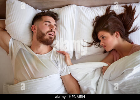 couple Problem with snoring in bed Stock Photo