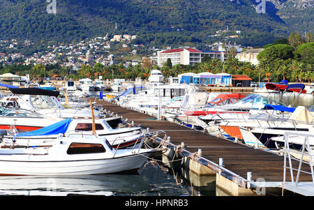 Pier with moored boats and yachts on a sunny day Stock Photo