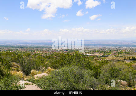 Panoramic view of Albuquerque, USA, from the starting point of Sandia Peak Tramway, in the foreground rocks and scrubs. Stock Photo