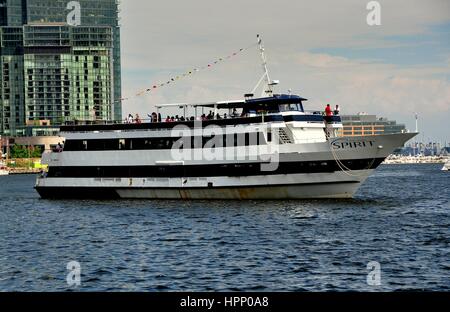 Baltimore, Maryland - July 22, 2013:  The Spirit of Baltimore cruise ship plies the waters of Inner Harbor with tourists on the top deck taking in the Stock Photo