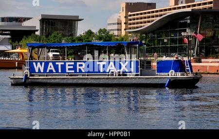 Baltimore, Maryland - July 22, 2013:  A city public transport water taxi arriving at the Inner Harbor stop Stock Photo