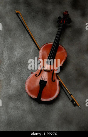 Violin and bow on gray background Stock Photo
