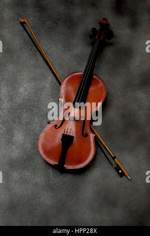 Violin and bow on gray background Stock Photo
