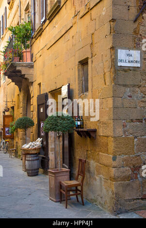 Street corner with Via Dell Amore road sign in Medieval town of Pienza, Tuscany, Italy Stock Photo