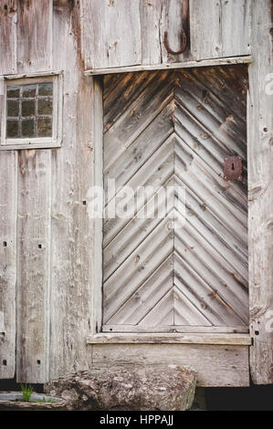 Old Rustic wooden farm door in Norway Stock Photo