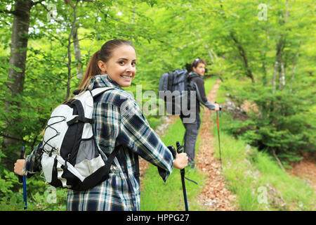 Young couple enjoying nordic walking in a forest Stock Photo