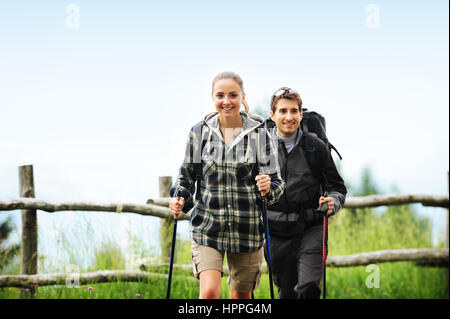 Young cheerful couple enjoying a nordic walk Stock Photo