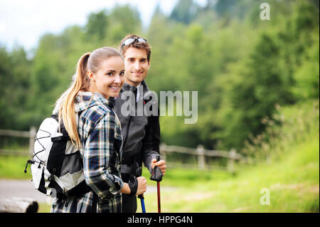 Young cheerful couple enjoying a nordic walk Stock Photo