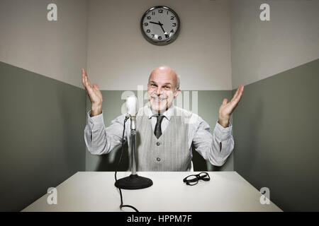 Confident senior businessman giving a speech on the microphone. Stock Photo