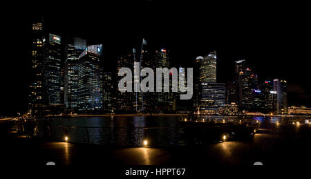 A 2 picture stitch panoramic cityscape view at night of the tower blocks and skyscrapers of the Central Business District (CBD) in Singapore. Stock Photo