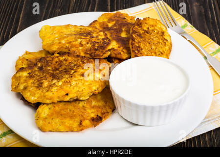 Vegetable fritters with sour cream. Studio Photo Stock Photo