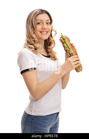 Pretty girl having a sandwich and looking at the camera isolated on white background Stock Photo