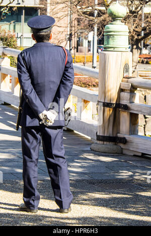 Rear of sentry guard standing on edge of Takebashi Bridge outside of the Hirakawa-mon gate of the Edo Castle, now Tokyo Imperial Palace. Stock Photo