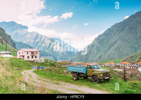 Georgia. GAZ-53 - Old Soviet Russian medium-duty truck parking near village Tsdo in summer mountains landscape in Darial Gorge, Georgia. Stock Photo