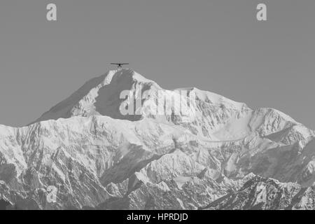 A small flight-seeing plane heads for Denali mountain, Mount McKinley, in Alaska, United States. Stock Photo