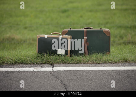 A Old Suitcase  beside the Road. Stock Photo