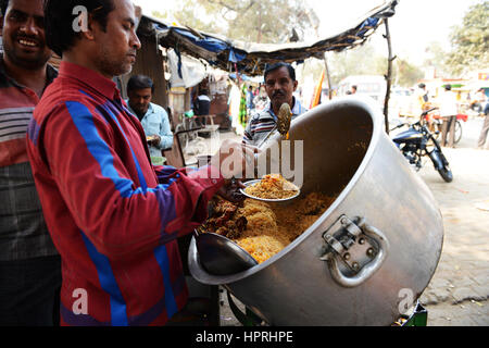 A Biryani vendor serving Chicken Biryani from his pot in Kannauj, Uttar Pradesh, India. Stock Photo