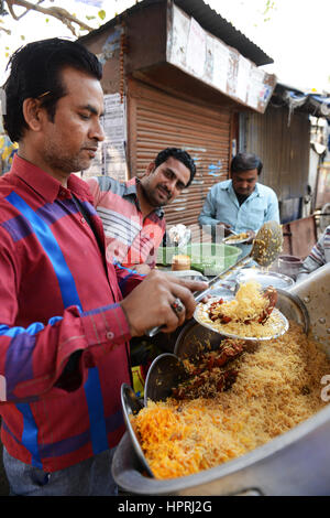 A Biryani vendor serving Chicken Biryani from his pot in Kannauj, Uttar Pradesh, India. Stock Photo