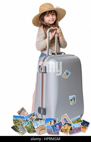Long haired little girl with straw hat is standing and leaning on a suitcase. Photos of the sights of Provence (France) flies around the suitcase. All Stock Photo