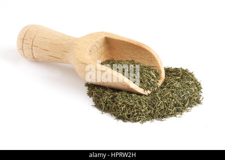 Pile of dried dill weed with wooden scoop isolated on white background Stock Photo