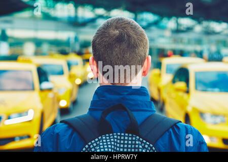 Handsome traveler is waiting for taxi at the airport. Stock Photo