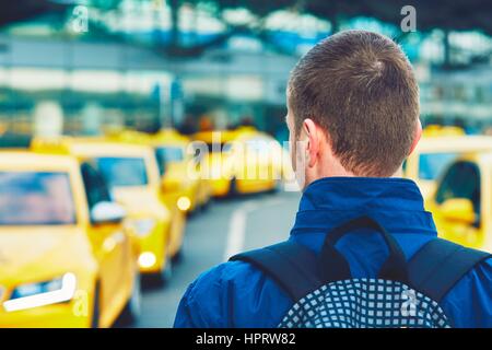 Handsome traveler is waiting for taxi at the airport. Stock Photo