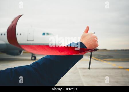 Member of ground crew is showing OK sign to pilot before take off. Stock Photo