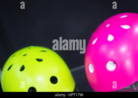 Inline and quad roller skates helmets head protection in retail skate shop display on sale. Stock Photo