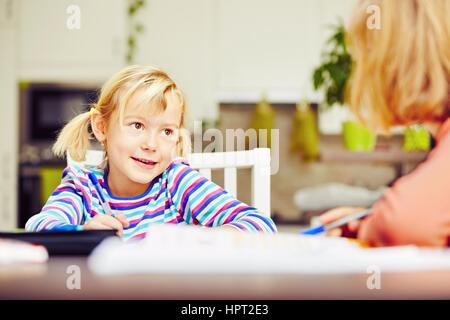 Little siblings are is doing his homework for elementary school. Stock Photo