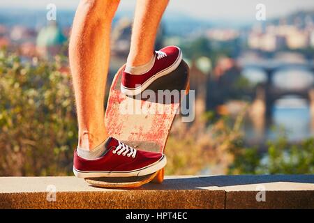 Young skateboarder is riding on the skateboard in the city. Prague, Czech Republic. Stock Photo