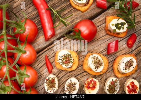 crunchy baguette slices with cream cheese and herbs Stock Photo