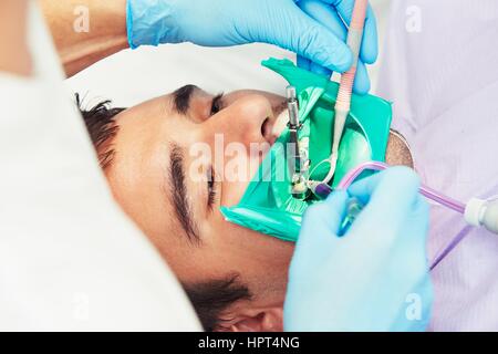 Dentist office - young man in the dentist chair Stock Photo