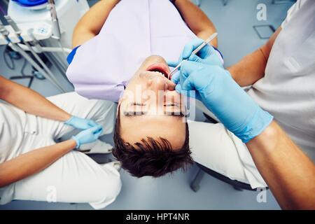 Dentist office - young man in the dentist chair Stock Photo