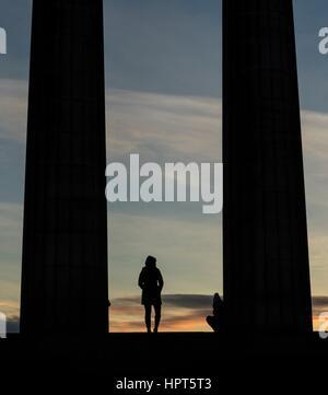 Edinburgh, UK. 24th Feb, 2017. UK Weather. Sunrise on Calton Hill, Edinburgh. Visitors stand on the National Monument watching the sun rise, Credit: Rich Dyson/Alamy Live News
