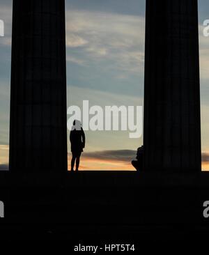 Edinburgh, UK. 24th Feb, 2017. UK Weather. Sunrise on Calton Hill, Edinburgh. Visitors stand on the National Monument watching the sun rise. Credit: Rich Dyson/Alamy Live News