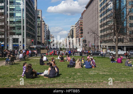 Washington, DC, USA. 24th February, 2017. For second day in a row with temperatures in upper 70's (F), lunchtime crowd soaks up the sun in Farragut Square, enjoying what meteorologists are saying will be the warmest February on record. Credit: Bob Korn/Alamy Live News Stock Photo