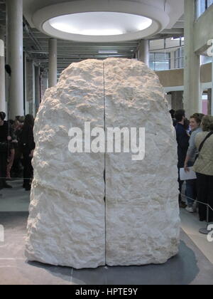 Paris, France. 22nd Feb, 2017. Journalists watch as the French artist Abraham Poincheval is sealed into a large rock for an unspecified period of time in the Museum Palais de Tokyo in Paris, France, 22 February 2017. The rock is fitted with a pipe which will allow the artist to breathe and a monitor to record his heart rhythm. Credit: dpa/Alamy Live News Stock Photo