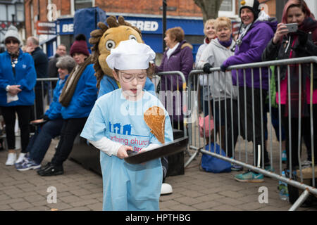 Littlehampton, West Sussex, UK. 25th Feb, 2017. Organised by the Littlehampton Town Council, the Pancake Olympics event is held each year in the town and raises money for charity. In Photo: A girl takes part in the pancake flipping event. Credit: Scott Ramsey/Alamy Live News
