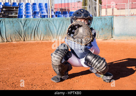 Female catcher ready to catch the ball during a baseball game Stock Photo