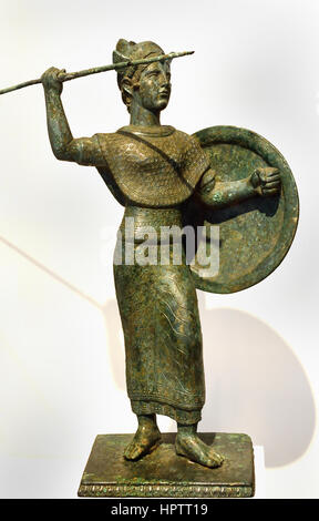 Etruscan goddess Menvra 400 BC  modelled on Greek figures of Pallas Athena, or Palladion, with raised spear (or lance) and shield and wearing the aegis. The helmet, similar in form to the Attic helmet worn on Greek copies of the Athena Parthenos is shown with the cheek flaps raised. Unusually, the goddess is barefoot, lacking the usual sandals . Etruria, Tuscany, Italy, Stock Photo